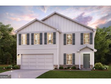 Charming two-story home with a two-car garage, green shutters, and beautiful landscaping at 4576 Sunrise Rdg, Covington, GA 30016