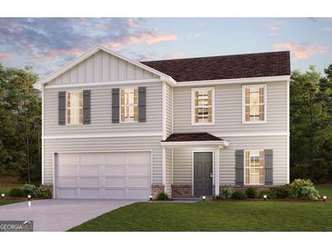 Charming two-story home featuring gray siding, a two-car garage, and manicured landscaping, offering curb appeal at 4622 Sunrise Rdg, Covington, GA 30016