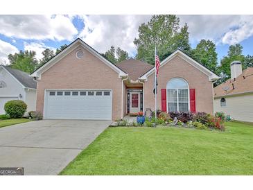 Charming brick home with a well-manicured lawn and vibrant flowerbeds enhancing curb appeal at 170 Habersham Dr, Fayetteville, GA 30214