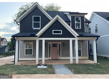 Charming new two-story home featuring a welcoming front porch and a pink front door at 3189 Jackson, Hapeville, GA 30354