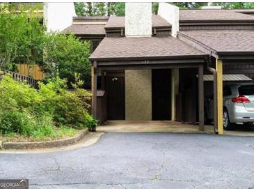 Townhome with a covered carport and well-maintained landscaping at 53 Cobblestone Crk, Peachtree City, GA 30269