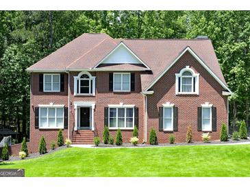 Charming brick home with black shutters, manicured lawn, and mature landscaping at 20 Allie Dr, Mcdonough, GA 30252