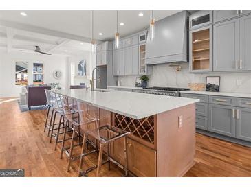 Modern kitchen island with a white countertop, wine rack, and seating for a perfect gathering space at 2018 Presley, Atlanta, GA 30317