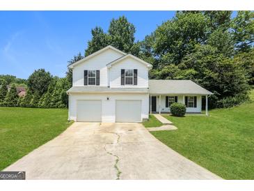 Charming two-story home with a two-car garage and well-maintained front yard, perfect for suburban living at 3587 Oakvale Ave, Decatur, GA 30034