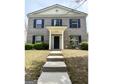 Charming two-story brick home featuring a welcoming entrance and well-maintained landscaping at 2517 Walter Way, Stockbridge, GA 30281