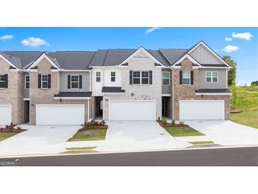 Charming townhomes showcasing unique exteriors, two-car garages, and well-maintained landscaping at 325 Silver Moon Dr, Loganville, GA 30052