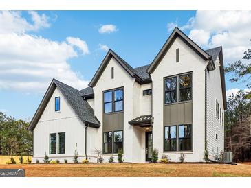 Stunning two-story home with white brick, dark trim, and modern farmhouse details at 3735 Tamiami Trl, Cumming, GA 30041