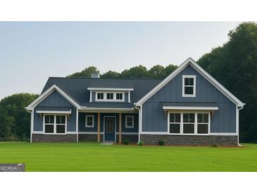 Charming blue home featuring stone accents, a covered porch, and large windows showcasing curb appeal at 1273 Jersey Social Circle Rd, Covington, GA 30014