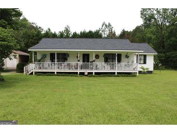 Charming single-Gathering home with a covered front porch, set on a lush green lawn at 124 Wynn Rd, Mcdonough, GA 30252