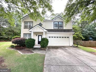 Charming two-story home featuring a well-manicured lawn, a two-car garage and welcoming front porch at 3814 Clear Lake Nw Way, Acworth, GA 30101