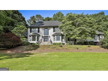 Charming two-story home with a well-manicured lawn, brick exterior, and lots of curb appeal at 209 Smokerise Trce, Peachtree City, GA 30269