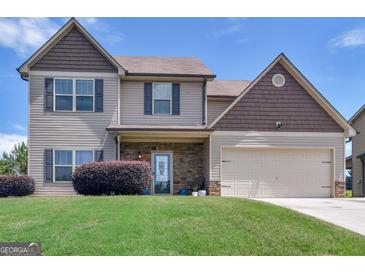 Charming two-story home with stone accents, two-car garage, and well-maintained lawn at 138 Brookhaven Dr, Villa Rica, GA 30180