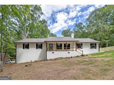 Charming ranch-style home with a welcoming front porch and freshly painted white brick at 126 Country Acres Ct, Mcdonough, GA 30253