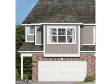 Charming townhome with a brick-accented two-car garage and neutral siding, offering a welcoming curb appeal at 2040 Piccolo Ct # 224, Mcdonough, GA 30252
