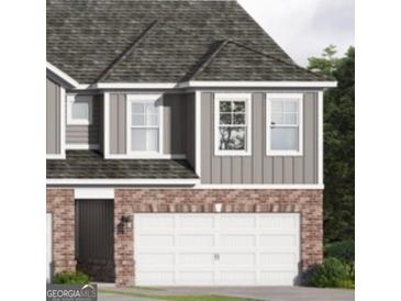 Charming two-story home showcasing a two-car garage and mixed brick and siding facade at 2020 Piccolo Ct # 229, Mcdonough, GA 30252