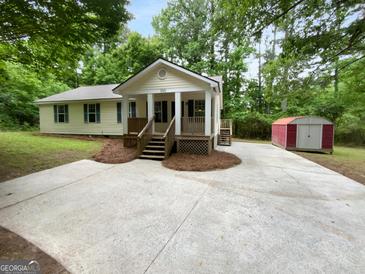 Charming single-Gathering home with a well-maintained lawn and inviting front porch at 355 New Marietta Hwy, Roswell, GA 30075