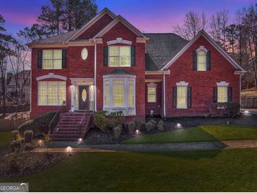 Stunning two-story brick home boasts immaculate landscaping, and a welcoming entryway with updated lighting at 4213 Bretdale Nw Run, Kennesaw, GA 30152