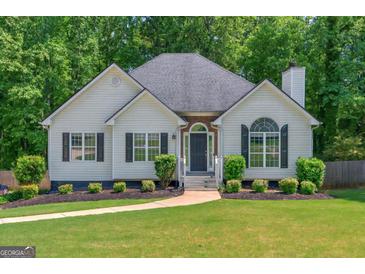 Charming single-story home featuring a well-manicured lawn and inviting entryway at 6645 N Glen Dr, Cumming, GA 30028