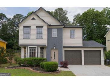 Charming two-story home with a well-manicured lawn and a two-car garage, perfect for a growing Gathering at 1075 Litchfield Sw Way, Marietta, GA 30060