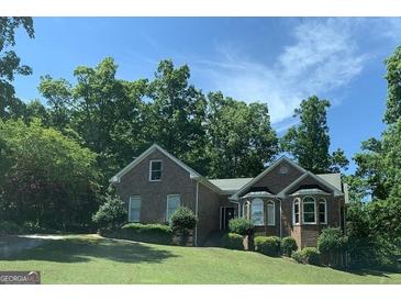 Charming brick home with mature trees, well-maintained lawn, and inviting curb appeal at 9160 Woodhaven Way, Mcdonough, GA 30253
