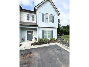 Charming two-story home with light blue siding and gray shutters at 7728 Fawn Cir, Covington, GA 30014