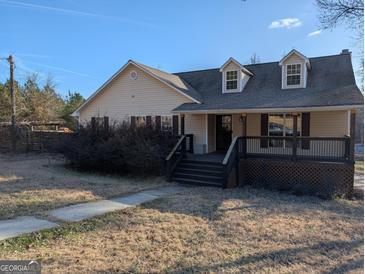 Charming single-story home featuring a welcoming front porch and well-maintained landscaping at 5700 Miles Rd, South Fulton, GA 30349