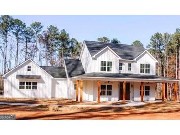Charming farmhouse style home with a welcoming front porch and classic white siding at 253 E Crestwood Rd, Tyrone, GA 30290
