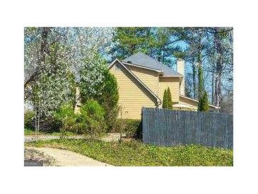Charming home with a gray roof, light yellow siding, and a classic brick chimney at 2366 Battle Forest Sw Dr, Marietta, GA 30064