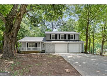 Charming two-story home featuring a covered porch, stone accents and a two car garage at 2894 Cushing Ct, Jonesboro, GA 30236
