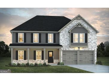 Charming two-story home features a classic design with a welcoming front porch and attached two-car garage at 1672 Fuma Leaf Way Rd, Mcdonough, GA 30253