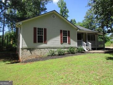 Charming single-story home with red shutters, and a cozy front porch at 4382 Highway 42 S, Locust Grove, GA 30248