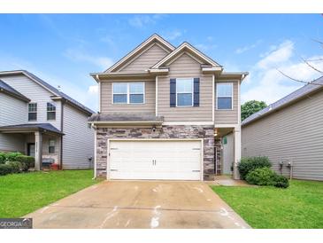 Charming two-story home featuring a stone facade and a two-car garage at 2577 Shropshire Pl, Mcdonough, GA 30253