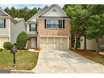 Charming brick-front home with a two-car garage and well-maintained lawn in a residential neighborhood at 737 Shadow Lake Dr, Lithonia, GA 30058