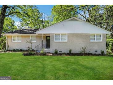 Charming single-story home with a well-manicured lawn and mature trees in a tranquil setting at 2896 Hogan Rd, East Point, GA 30344