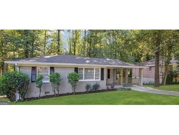 Charming single-story home featuring a well-manicured lawn and mature trees at 2364 Farley St, East Point, GA 30344