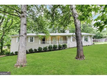 Charming single-story home features a welcoming front porch, fresh lawn and tidy landscaping at 6236 Shallow Creek Ln, Douglasville, GA 30135