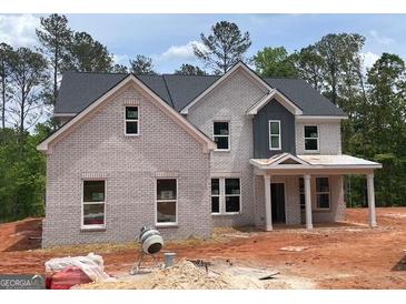 Beautiful new construction home with light brick facade and welcoming front porch at 3292 Mill Forest Sw Dr, Conyers, GA 30094