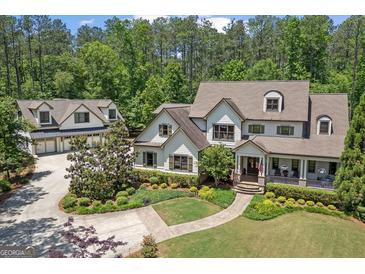 Beautiful two-story home with a charming front porch, mature landscaping, and a separate garage building at 193 Stonegate Trl, Carrollton, GA 30116