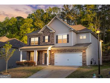 Beautiful two-story home with a brick and siding exterior and attached two car garage at 5229 Tye, Fairburn, GA 30213