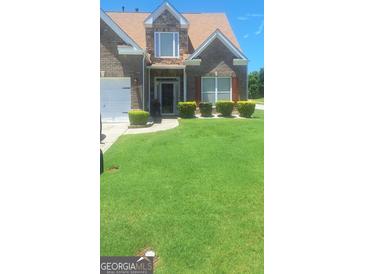 Charming two-story brick and stone home with a well-manicured lawn and inviting curb appeal at 7314 Basalt Dr, Union City, GA 30291