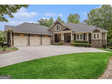 Charming home featuring a three-car garage, well-manicured lawn, and stone accents at 115 Edgewood Pkwy, Fayetteville, GA 30215