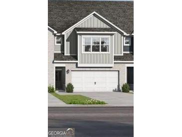 Two-story townhome featuring a two-car garage and neutral siding at 2306 Santa Fe St # 9, Morrow, GA 30260