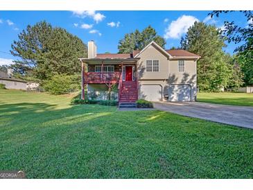Charming two-story home with a red front door, inviting porch, and well-maintained lawn and mature trees at 2006 Carrollton Hwy, Temple, GA 30179