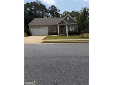 Charming single-story home featuring a brick facade, attached garage, and well-maintained front lawn at 170 Forray Dr, Covington, GA 30016