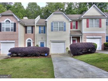 Charming townhouses with manicured lawns and colorful window shutters at 5640 Terremont Cir, Norcross, GA 30093