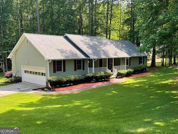 Charming single-story home with a welcoming front porch and well-maintained landscaping at 145 Adams Ct, Fayetteville, GA 30214