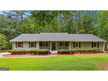 Charming single-story home with a well-manicured lawn and inviting front porch at 145 Adams Ct, Fayetteville, GA 30214