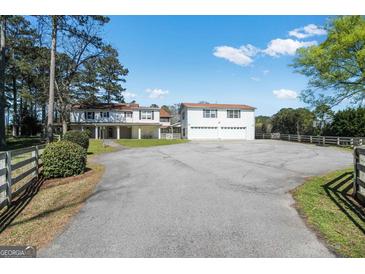 Sprawling two-story home with a spacious driveway and an oversized two-car garage at 387 Colvin Dr, Locust Grove, GA 30248