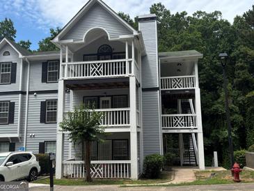 Three-story apartment building with gray siding, white railings, and exterior staircases and balconies at 3480 Shepherds Path, Decatur, GA 30034