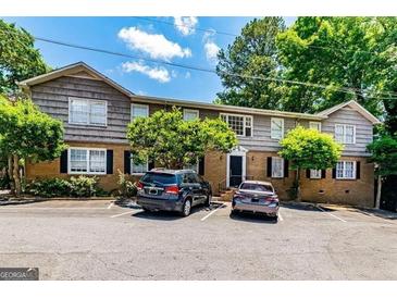 Apartment building features a mix of brick and wood siding with ample parking at 3626 Buford # C1, Brookhaven, GA 30329